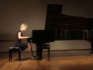 Woman Playing Grand Piano